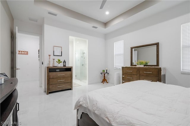 bedroom with ensuite bathroom, ceiling fan, and multiple windows