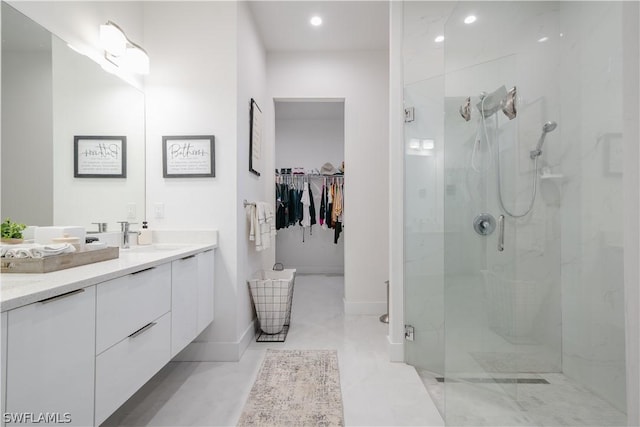 bathroom featuring vanity and a shower with door