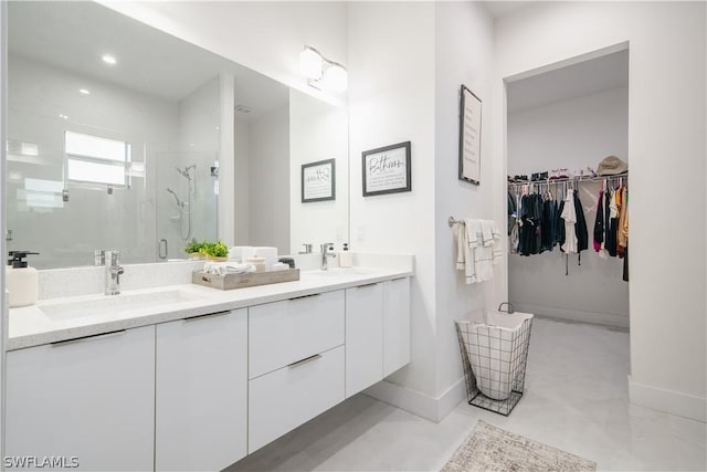 bathroom featuring a shower with door, vanity, and concrete floors