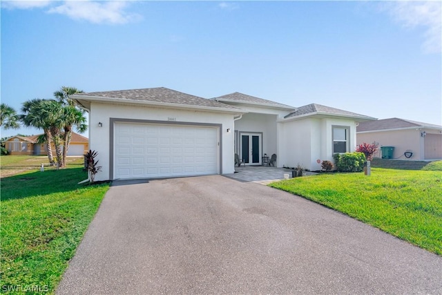 view of front of house with a garage and a front lawn