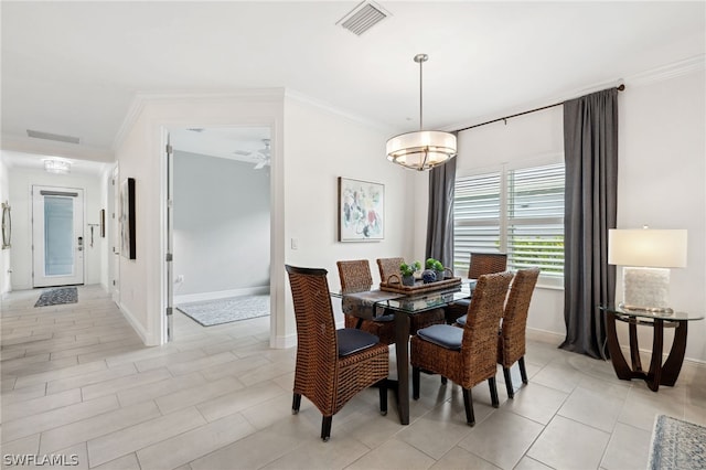 dining room with ceiling fan and crown molding