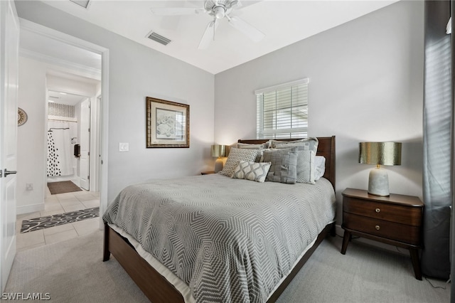 carpeted bedroom featuring ensuite bath and ceiling fan