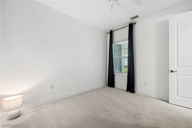 carpeted spare room with ceiling fan