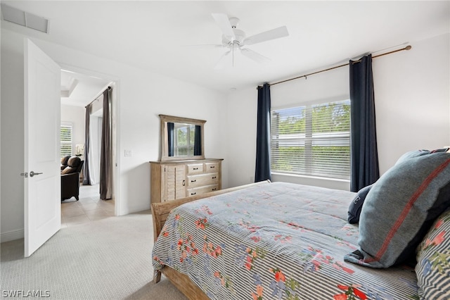 bedroom featuring light colored carpet and ceiling fan