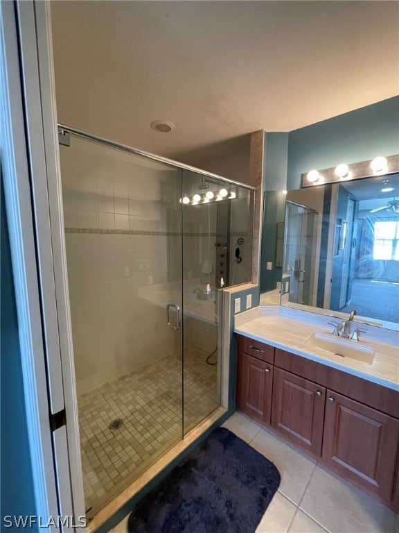 bathroom with tile patterned floors, vanity, and a shower with shower door