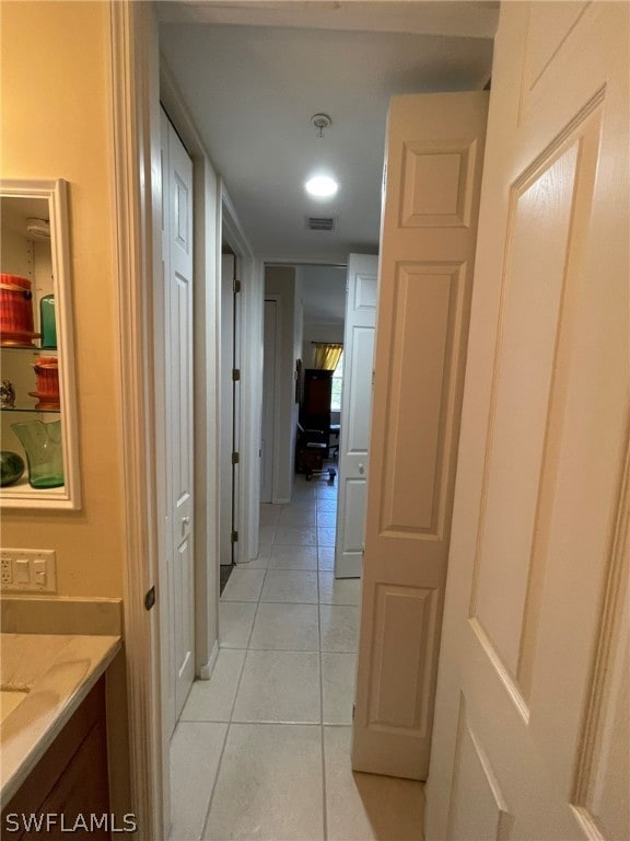 hallway featuring light tile patterned flooring