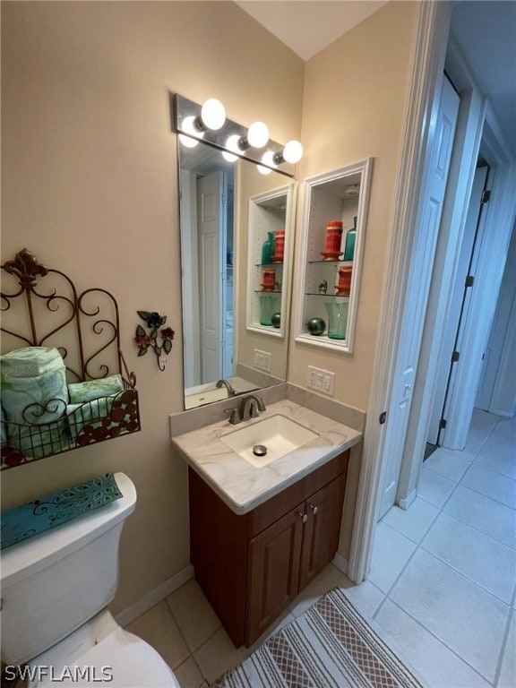 bathroom featuring tile patterned flooring, vanity, and toilet