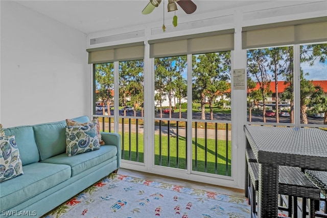 sunroom featuring ceiling fan and plenty of natural light