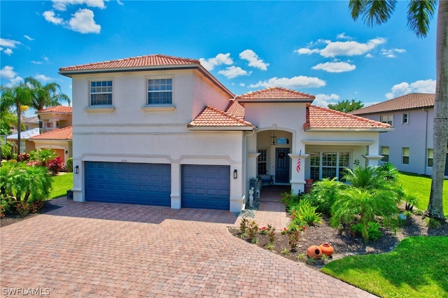 mediterranean / spanish-style home with a garage