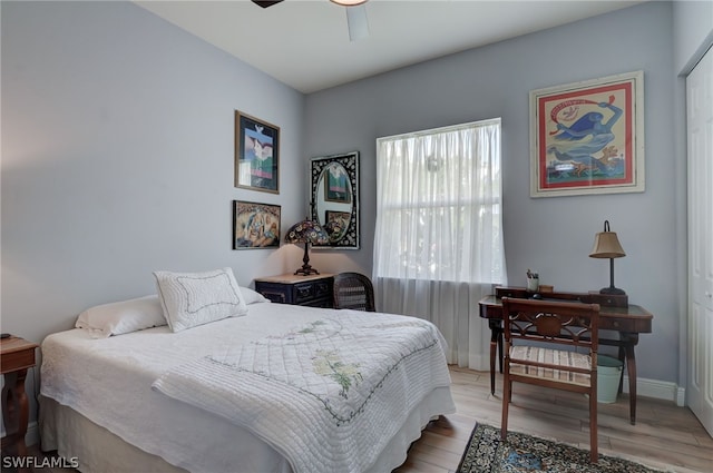 bedroom featuring a closet, light hardwood / wood-style floors, and ceiling fan