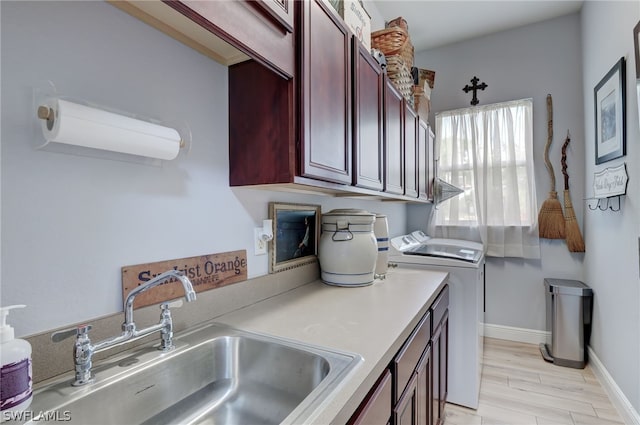 kitchen with sink, light hardwood / wood-style floors, and independent washer and dryer