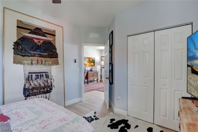 bedroom featuring a closet and light wood-type flooring