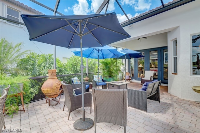 view of patio / terrace with french doors and a fire pit