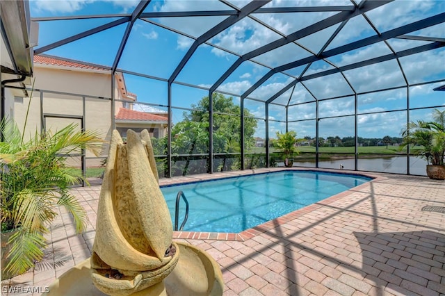 view of pool with glass enclosure, a water view, and a patio