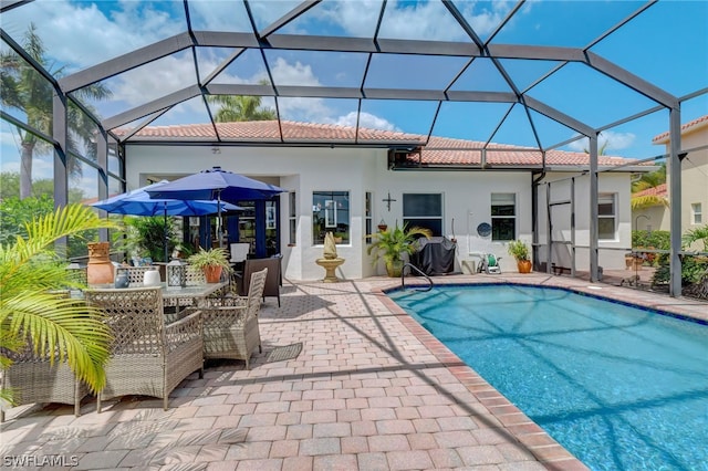 view of pool with a patio area and a lanai