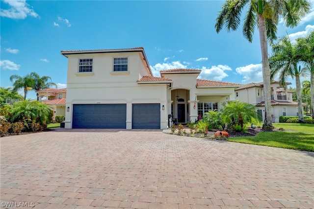 mediterranean / spanish home featuring a garage