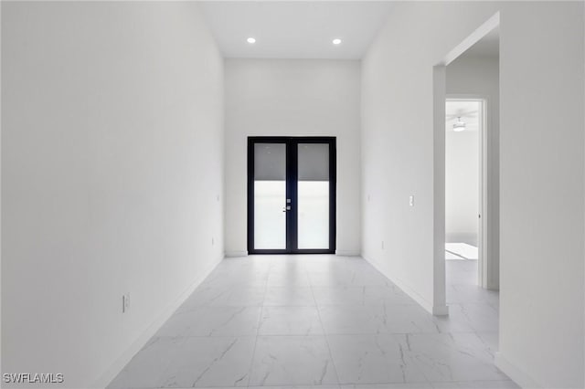 unfurnished room with ceiling fan and french doors