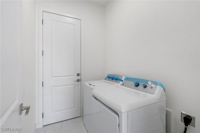 clothes washing area with separate washer and dryer