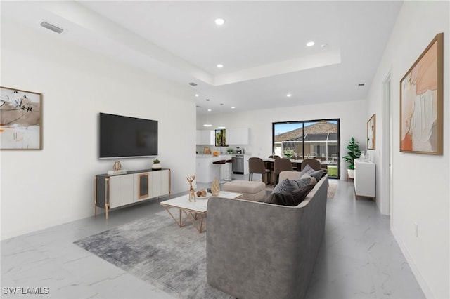 living room featuring a tray ceiling