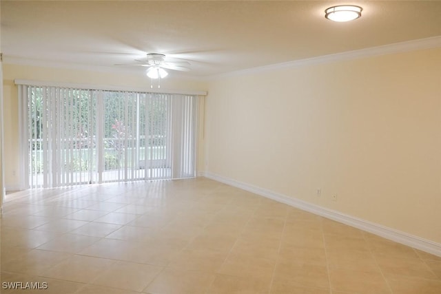 spare room with baseboards, ornamental molding, and a ceiling fan