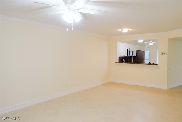 unfurnished room featuring baseboards, a ceiling fan, and crown molding