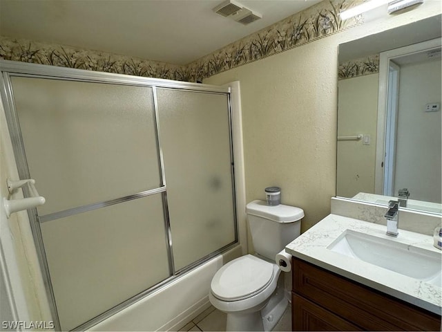 full bathroom with toilet, vanity, and combined bath / shower with glass door