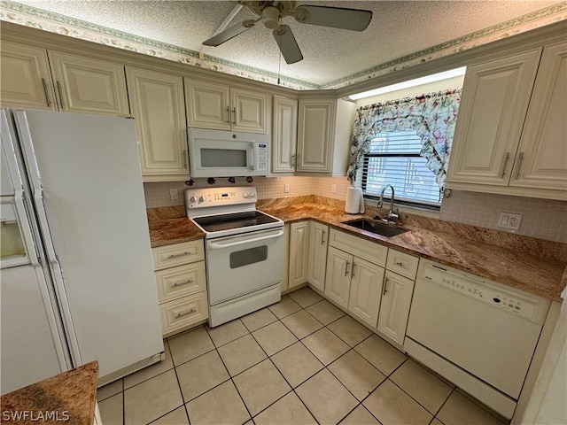 kitchen with white appliances, sink, ceiling fan, light tile patterned floors, and a textured ceiling