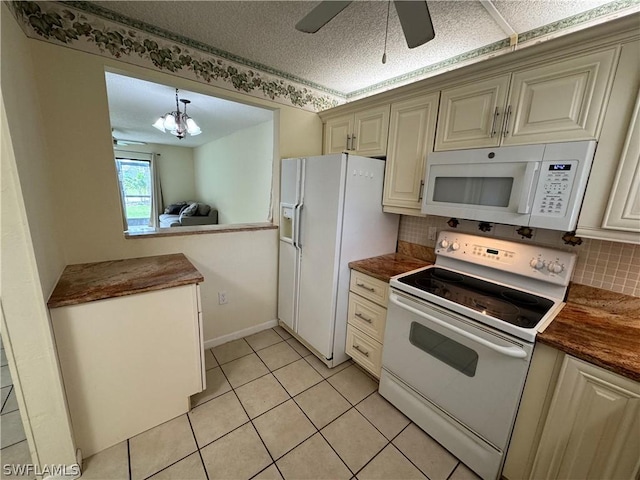 kitchen with white appliances, decorative backsplash, light tile patterned floors, a textured ceiling, and decorative light fixtures