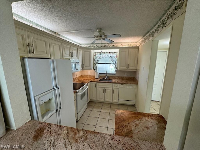 kitchen featuring a textured ceiling, white appliances, ceiling fan, sink, and light tile patterned floors