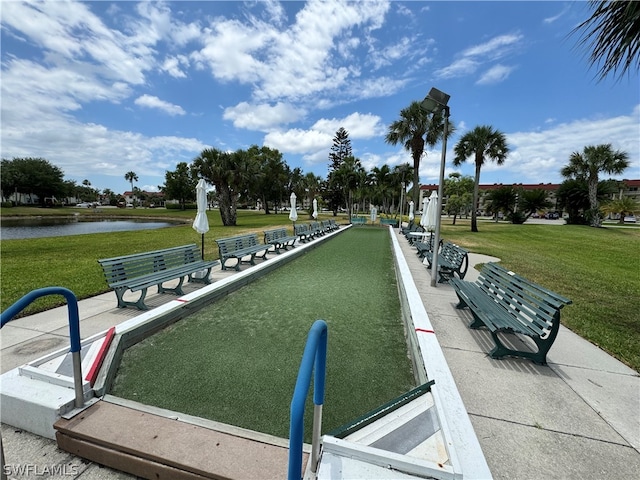 view of property's community with a yard and a water view