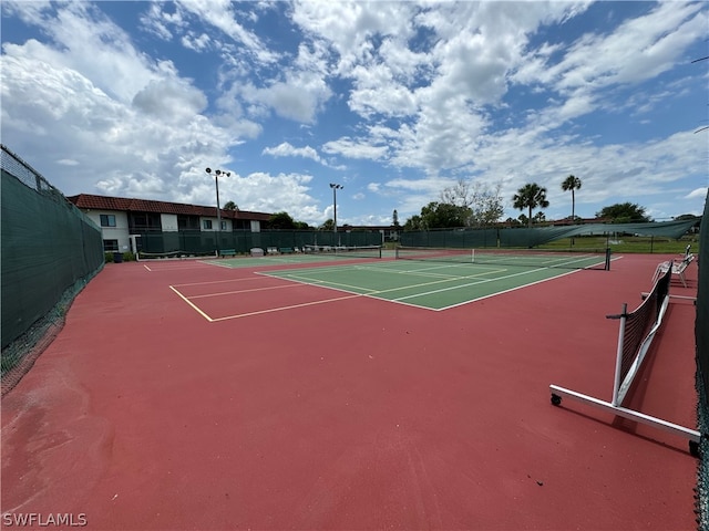 view of tennis court featuring basketball hoop