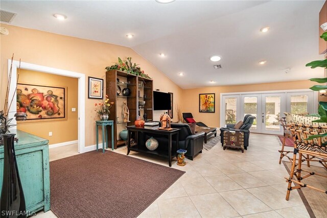 tiled living room with french doors and vaulted ceiling