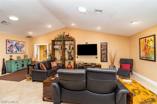 living room featuring vaulted ceiling and light tile floors