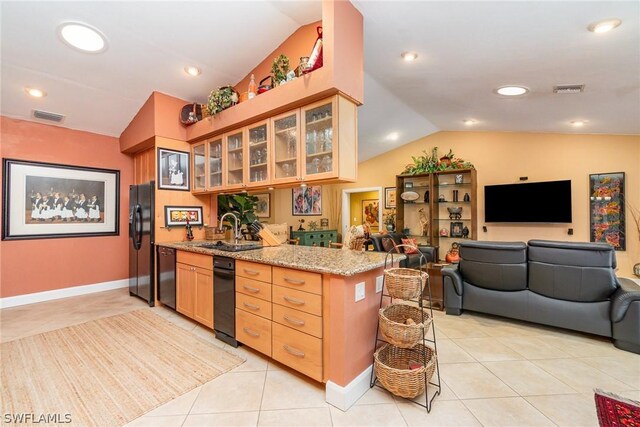 kitchen featuring black appliances, vaulted ceiling, kitchen peninsula, light stone counters, and light tile floors