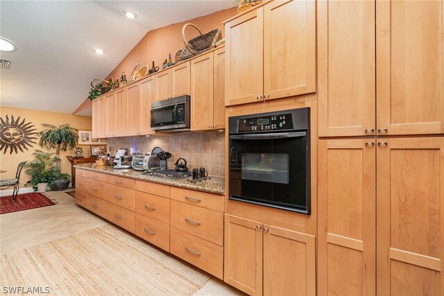 kitchen with light brown cabinets, backsplash, black appliances, light tile floors, and lofted ceiling