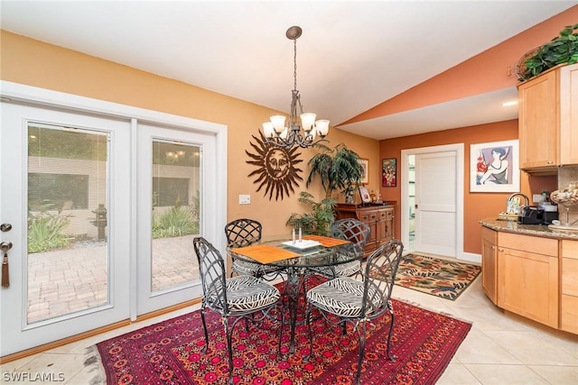 dining room with lofted ceiling, plenty of natural light, light tile patterned floors, and a notable chandelier