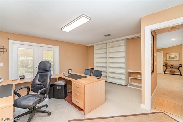 home office with french doors and light colored carpet