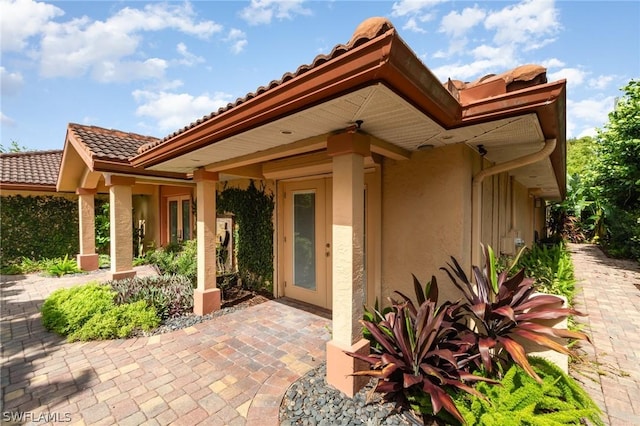 doorway to property with a patio