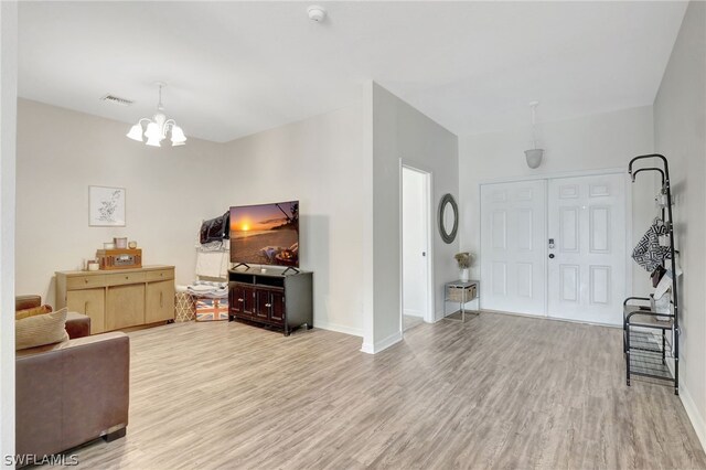 foyer featuring a notable chandelier and hardwood / wood-style flooring