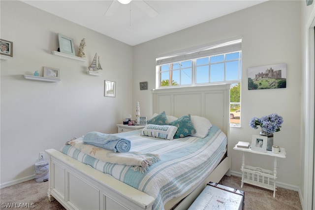 bedroom with baseboards, a ceiling fan, and light colored carpet