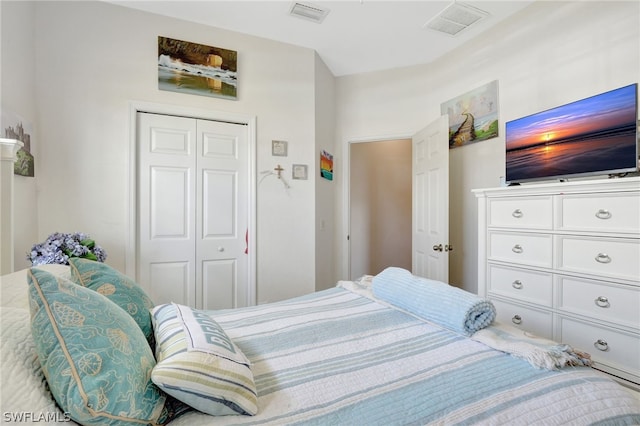 bedroom with a closet and visible vents