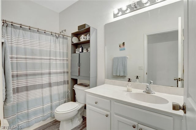 bathroom with hardwood / wood-style floors, toilet, and large vanity