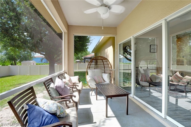 sunroom / solarium featuring ceiling fan