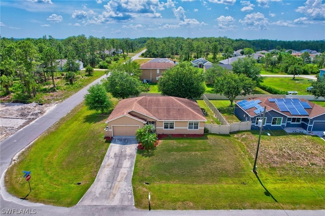 bird's eye view with a wooded view