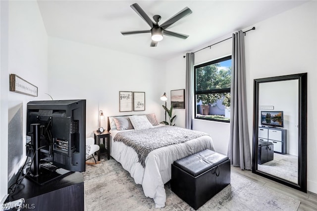 bedroom with a ceiling fan and light wood-style floors