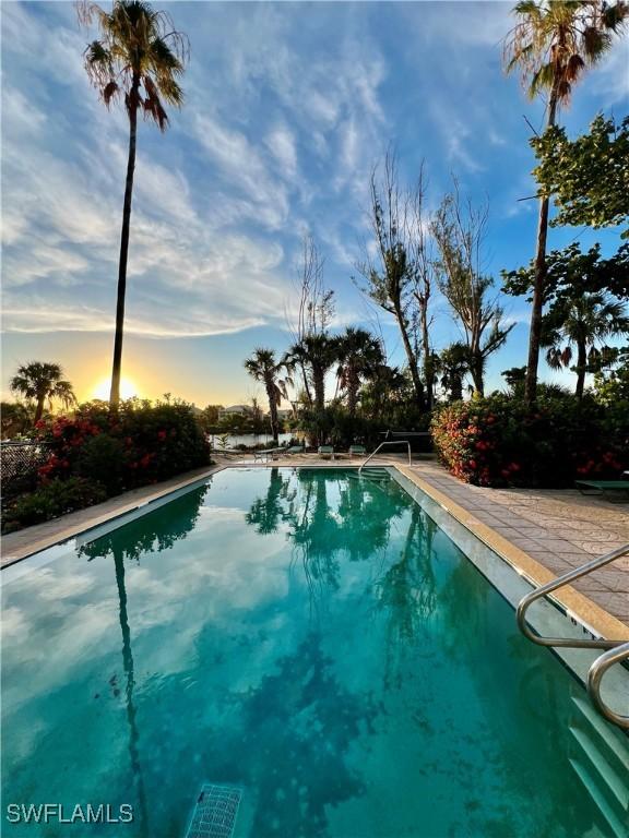 pool at dusk with a patio