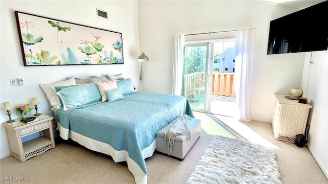 bedroom featuring access to exterior and light colored carpet