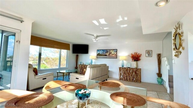 tiled dining area featuring ceiling fan