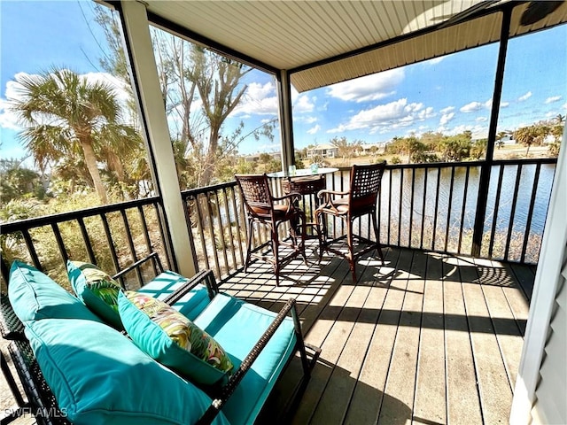 wooden terrace featuring an outdoor hangout area and a water view