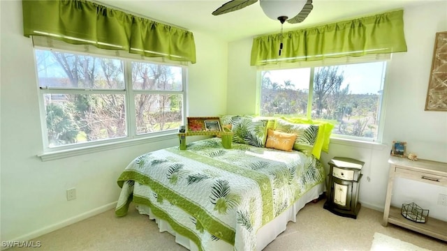 bedroom featuring carpet, multiple windows, and ceiling fan